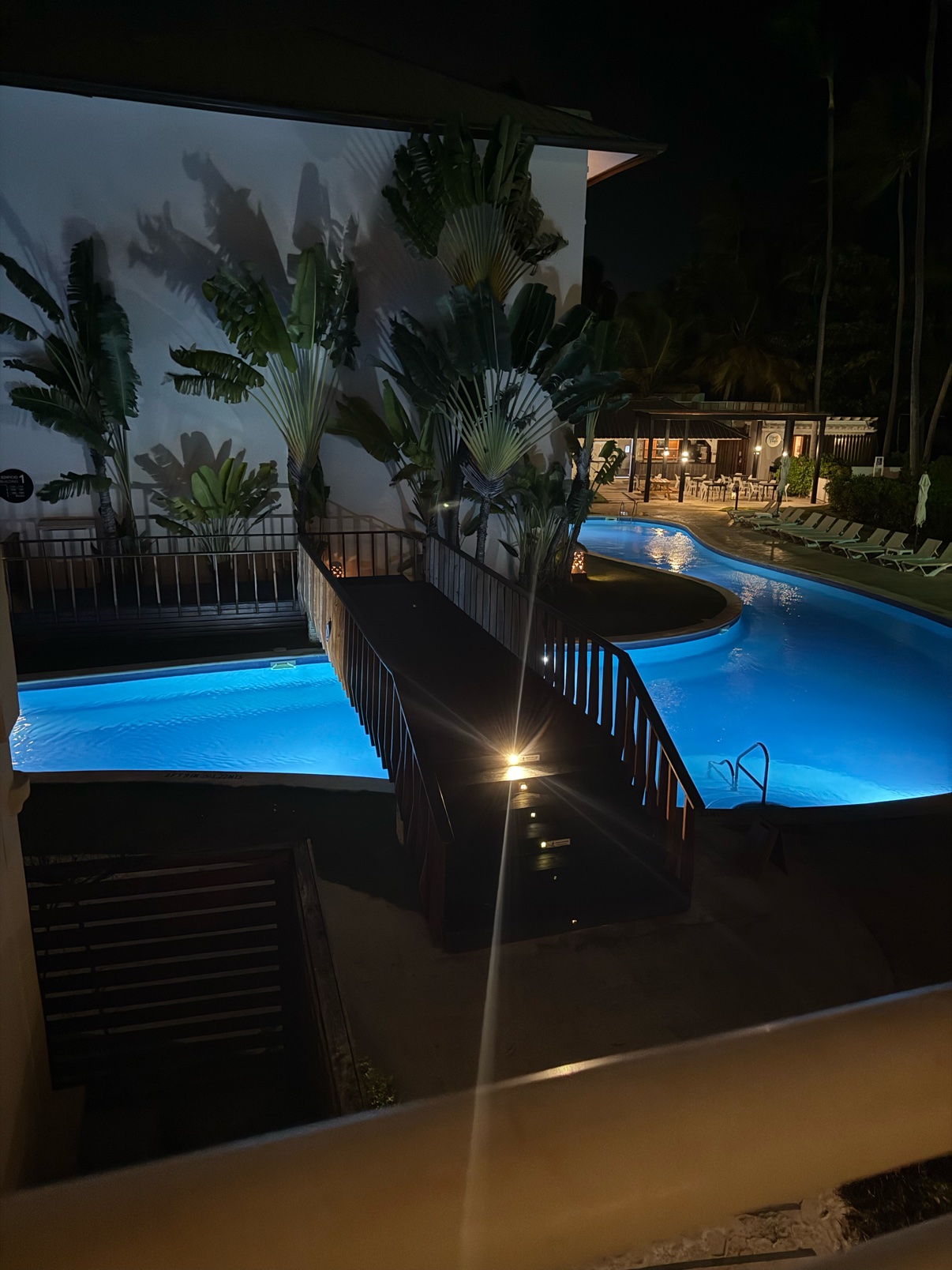 Resort pool glowing blue at night in the Dominican Republic